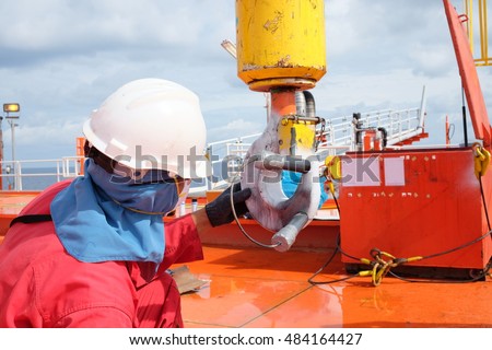 Magnetic particle Inspection for check crack on Crane hooks.Crane hooks on work site, Crane on Oil and gas platform for transfer cargo and Controlled by Crane operator. Royalty-Free Stock Photo #484164427