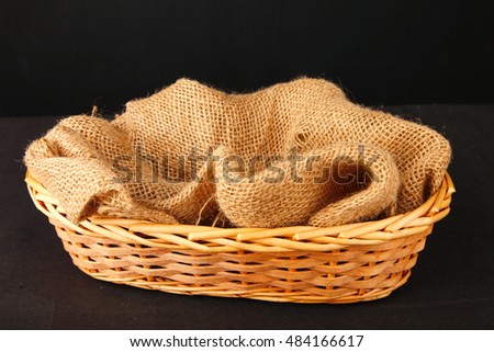Empty wooden basket with gunny sack