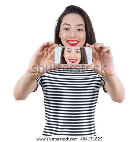 Happy  woman taking a selfie using her smartphone