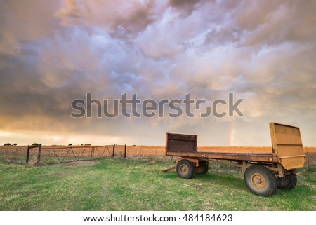 Old wagon under stormy skies with rainbow - South Africa