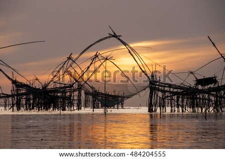 Sunrise with group of fish lift nets at Pakpra Canal, Thale Noi, Patthalung, Thailand