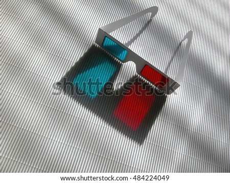 Stereo glasses made of paper and colored (red, cyan) film on relief white surface with nice shadows, front view