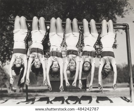 Showgirls hanging from monkey bars Royalty-Free Stock Photo #484242787