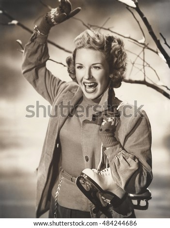 Happy woman carrying ice skates