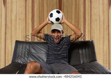 Men watching cheering sports fans soccer football at home enjoy the game
