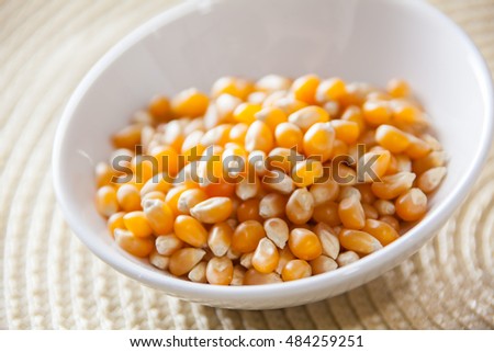 Close Up Of Popcorn Kernels In A White Bowl With Selective Focus.
