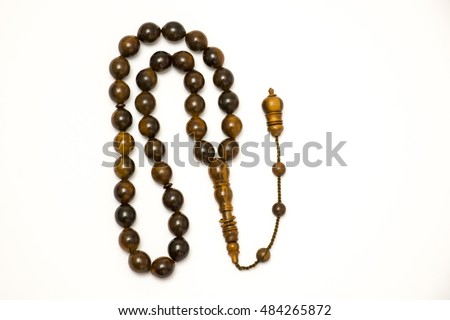 Brown prayer beads on white background Royalty-Free Stock Photo #484265872