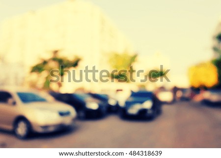blurred background of car in parking lot .