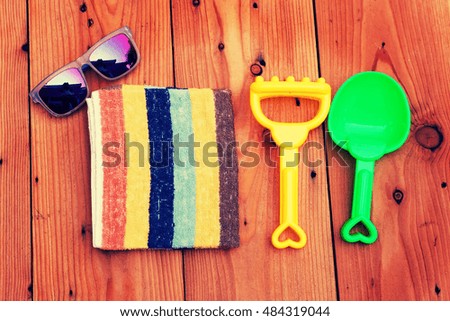 Summer accessories on wooden background.