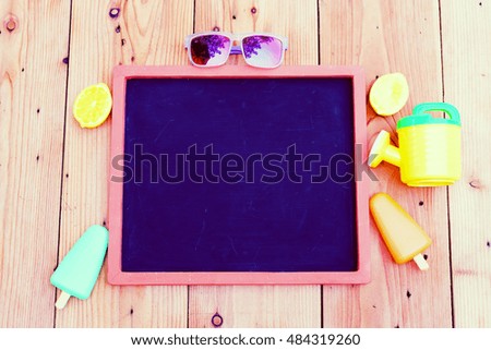 Blank blackboard with beach toys.
