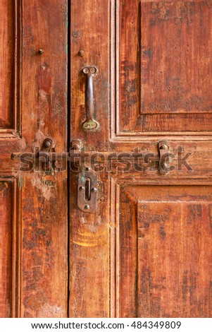 door knob on red old wooden door