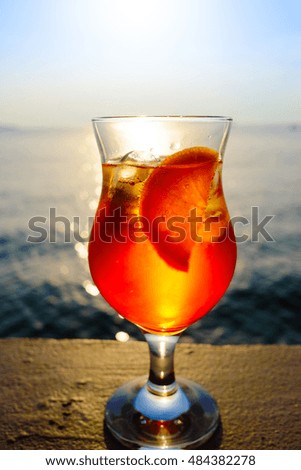 aperol spritz cocktail over the sea on sunset 
