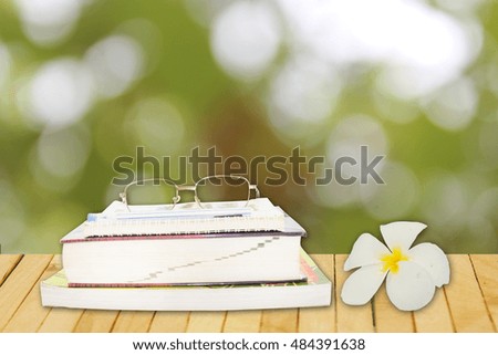 read a book outdoor garden with beautiful white flower and glasses
