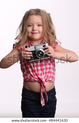 Little girl with camera. Close up. White background