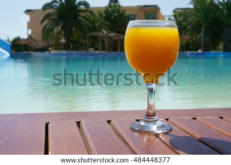 orange juice on a pool background