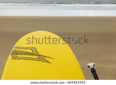 yellow surfboard and paddlesurf with row on the beach-hendaia-france