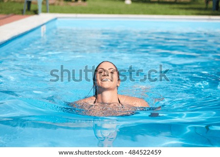 young woman relaxing at swimming pool