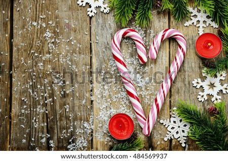 wood background with Christmas tree, candy, and snowflakes. toning. selective focus