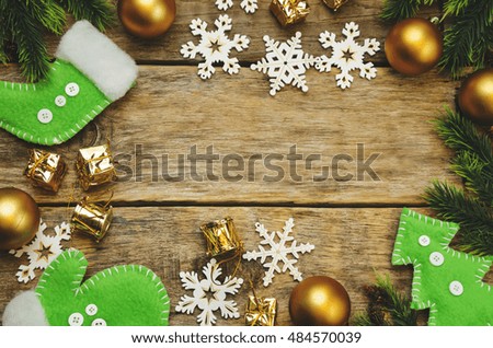 wood background with Christmas tree, snowflakes, Christmas balls and toys. toning. selective focus