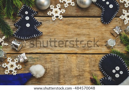 wood background with Christmas tree, snowflakes, Christmas balls and toys. toning. selective focus