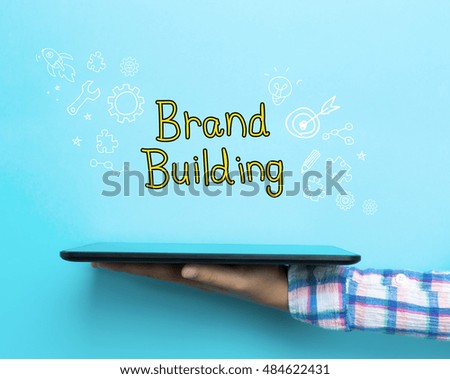 Brand Building concept with a tablet on blue background