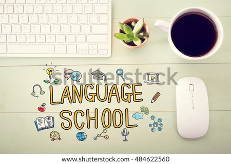 Language School concept with workstation on a light green wooden desk