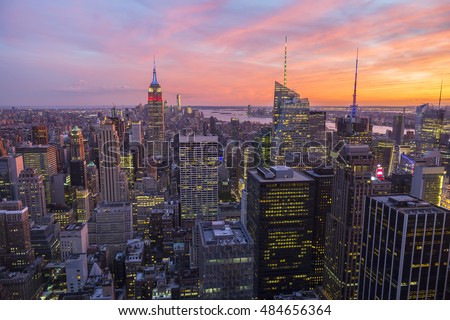 Bright golden pink sunset view of the Midtown Manhattan New York City skyline looking south 