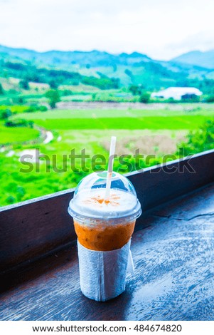 Iced Milk Tea in Plastic Glass with Natural View, Thailand.