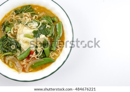 Delicious instant noodles with vegetables and egg. Copy space
