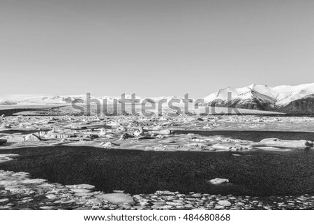 Black and White, Iceland winter lagoon with snow covered mountain background
