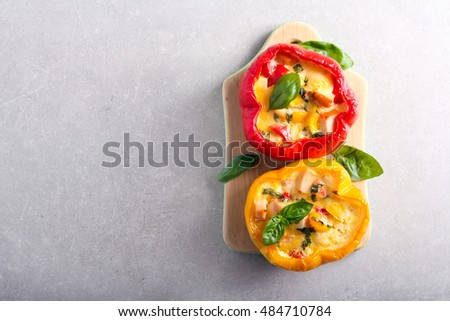 Baked bell pepper with chicken, cheese and egg filling, top view Royalty-Free Stock Photo #484710784