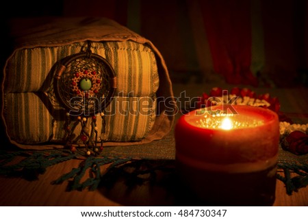 Night vintage style image of dreamcatcher on classics pillow and candle light. sweet dream.