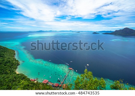 National Park on top of Bohey Dulang island near Sipadan Island,Sabah,Borneo.Mirror smooth ocean surrounded by mountains.The bright blue water and rocky shore in the tropical island of Semporna,Borneo