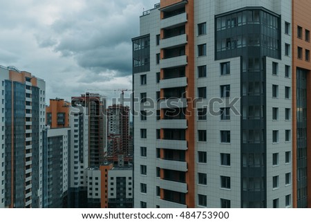 Multi-storey residential buildings, sleeping area. movement of clouds on a background of urban buildings.