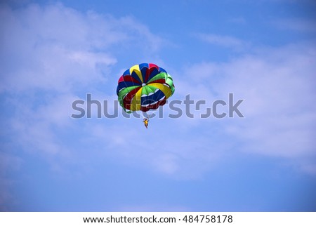 Woman flying a paraglider in the sky