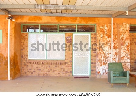 Vintage interior with retro chair in underground house to stay cool during heat waves, Coober Pedy, Australia