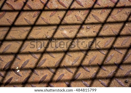grid shadow on ivory brown background, shadow from netting against red, netting shadow as texture, high quality resolution