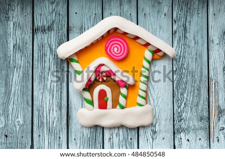Christmas decorative house on the wooden background