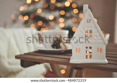 Christmas or new year decoration on modern wooden coffee table.  Living room interior and holiday home decor concept. Toned picture