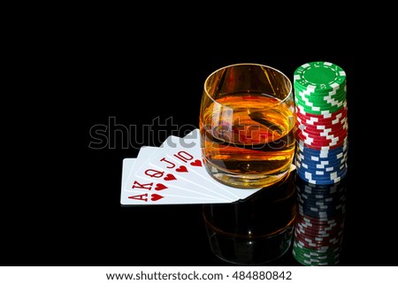 Playing cards with colorful chips to play poker and tumbler of whiskey