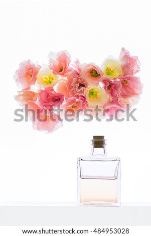 Beautiful jar with liquid  with eustoma flowers on  background
