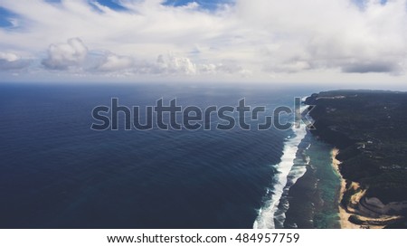 Aerial photo from flying drone of a fascinating nature landscape of green Asian island and sea with beautiful waves with copy space for your advertising text for travel agency. Amazing Indian Ocean
