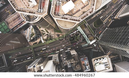 Top view aerial photo from flying drone of a tall skyscrapers with contemporary design, road with cars. Developed China city with commercial and financial centers. Buildings roofs in business district