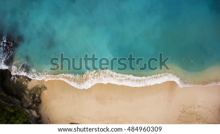 Top view aerial photo from flying drone of Indian Ocean seashore with beautiful color sea waves. Wonderful seascape with copy space for advertising text message. Perfect background for travel website