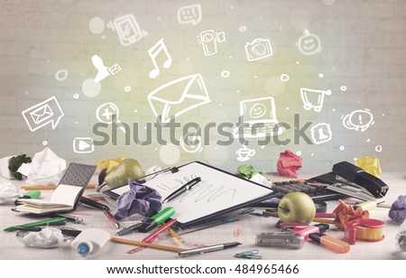 Social media online communication concept with icons and close up of business office desk full of work equipement