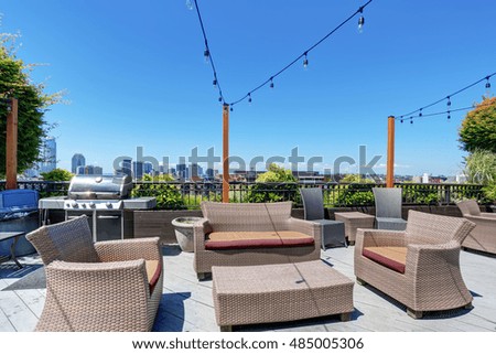Walkout deck of apartment building with many armchairs. Patio area.  Northwest, USA