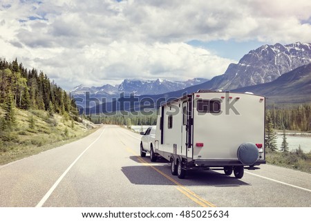 Caravan or recreational vehicle motor home trailer on a mountain road in Canada Royalty-Free Stock Photo #485025634