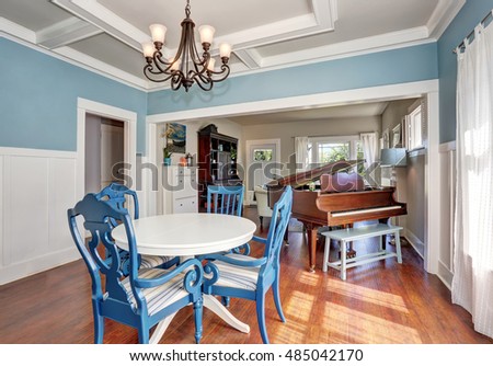Blue and white dining area with nice table set. Piano at the background. Northwest, USA