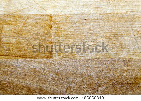   photographed close-up made from wood cutting board for food. on the board can be seen a lot of cuts from a knife