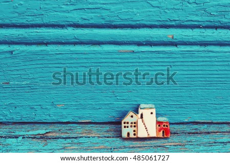 toy houses and blue  wooden background